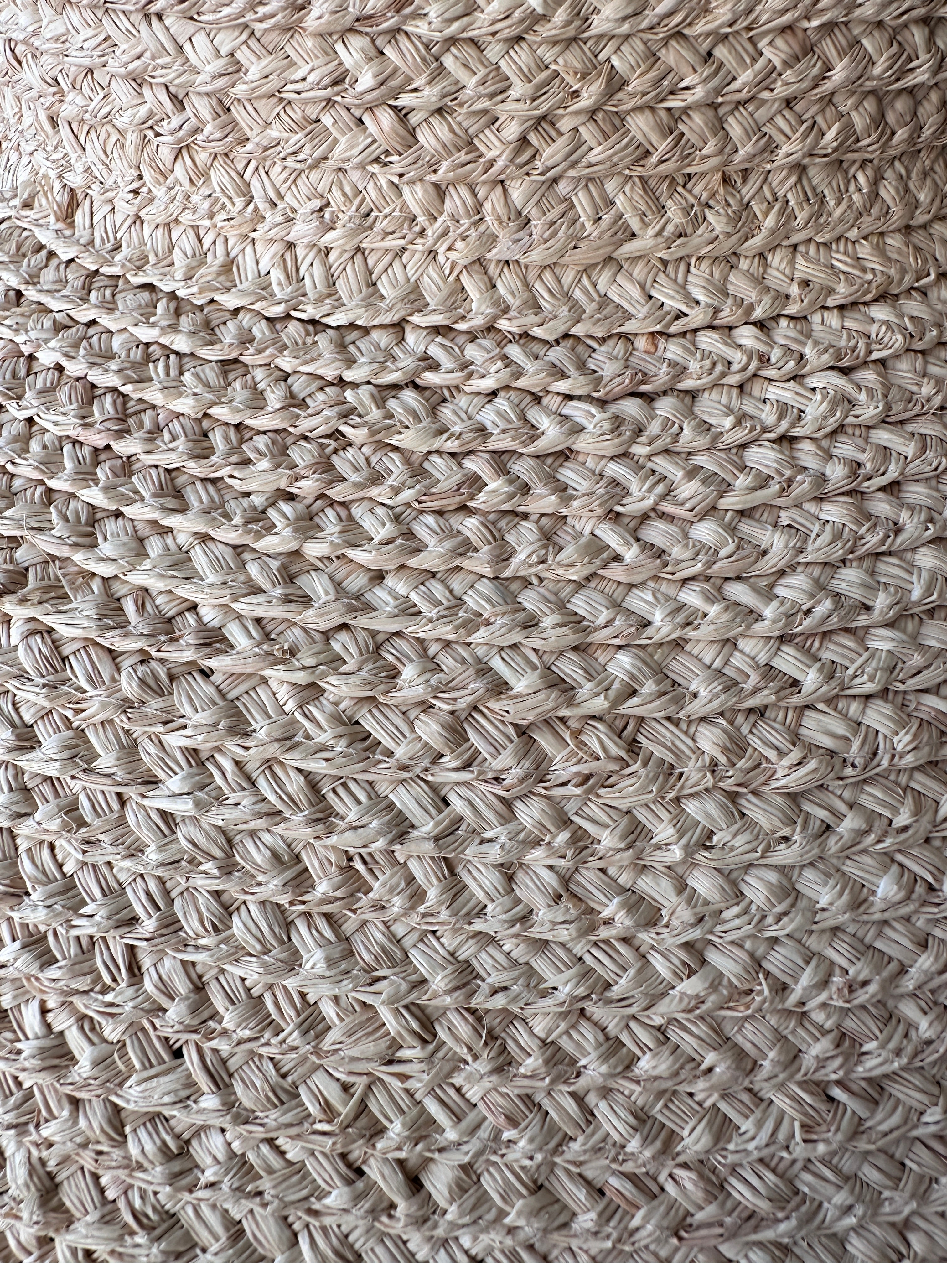 Close-up of raffia textured woven material with a neutral color palette.